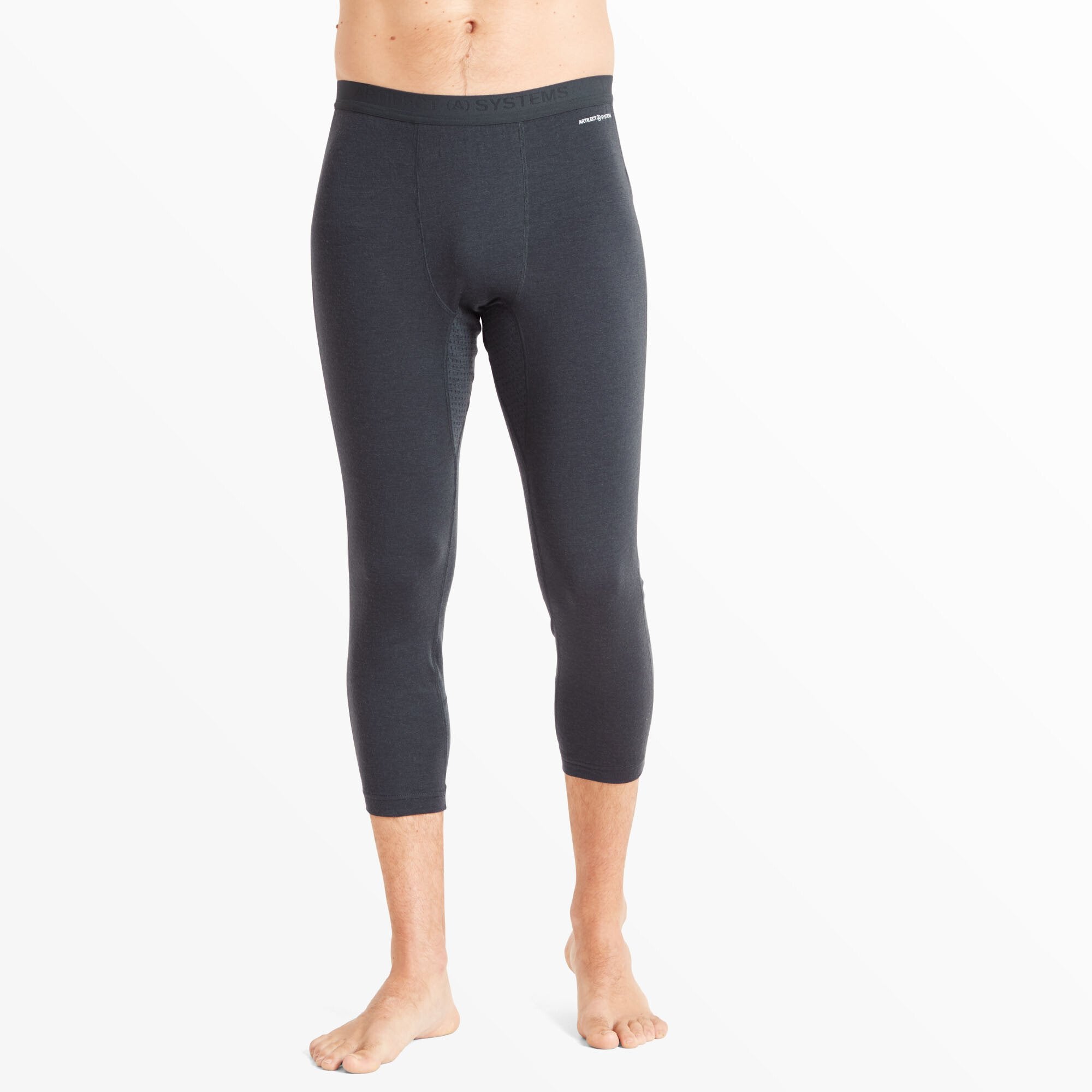 A man is shown from the waist down wearing Artilect Performance Mens Boulder 125 3/4 Legging Blue. The leggings are form-fitting and extend to mid-calf, featuring a simple design with flat seams and no visible branding on the front panel. The waistband sits high and snugly around the waist.