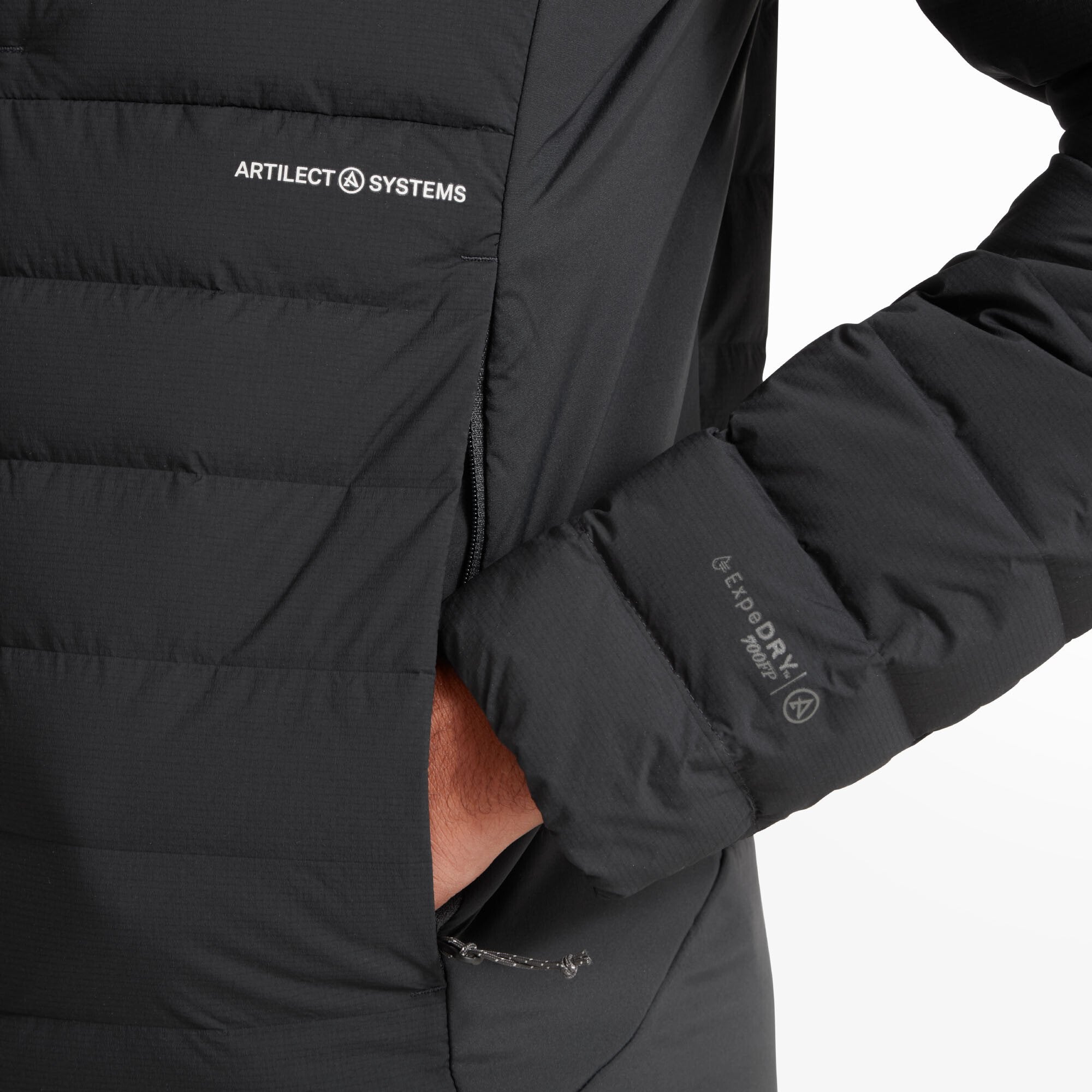 Close-up of the left chest and arm showing the "ARTILECT SYSTEMS" logo in white and the "EXPDRY POWER" marking on the cuff on the Artilect Performance Mens Divide Fusion Stretch Hoodie Black. The image also captures the zippered hand pocket and the texture of the quilted jacket material.