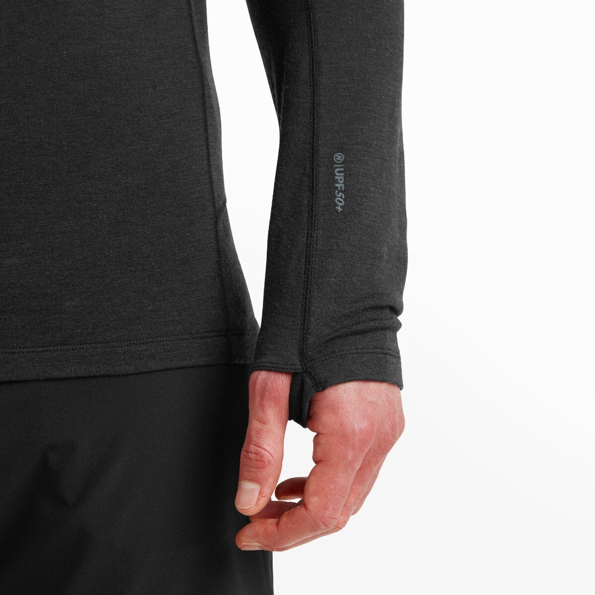 Close-up of the lower sleeve and thumbhole cuff on the Artilect Performance Mens Exposure Hoodie Black. The black fabric shows a subtle texture, with “UPF 50+” printed in gray near the wrist. The thumbhole opening exposes the model’s thumb and the back of his hand.