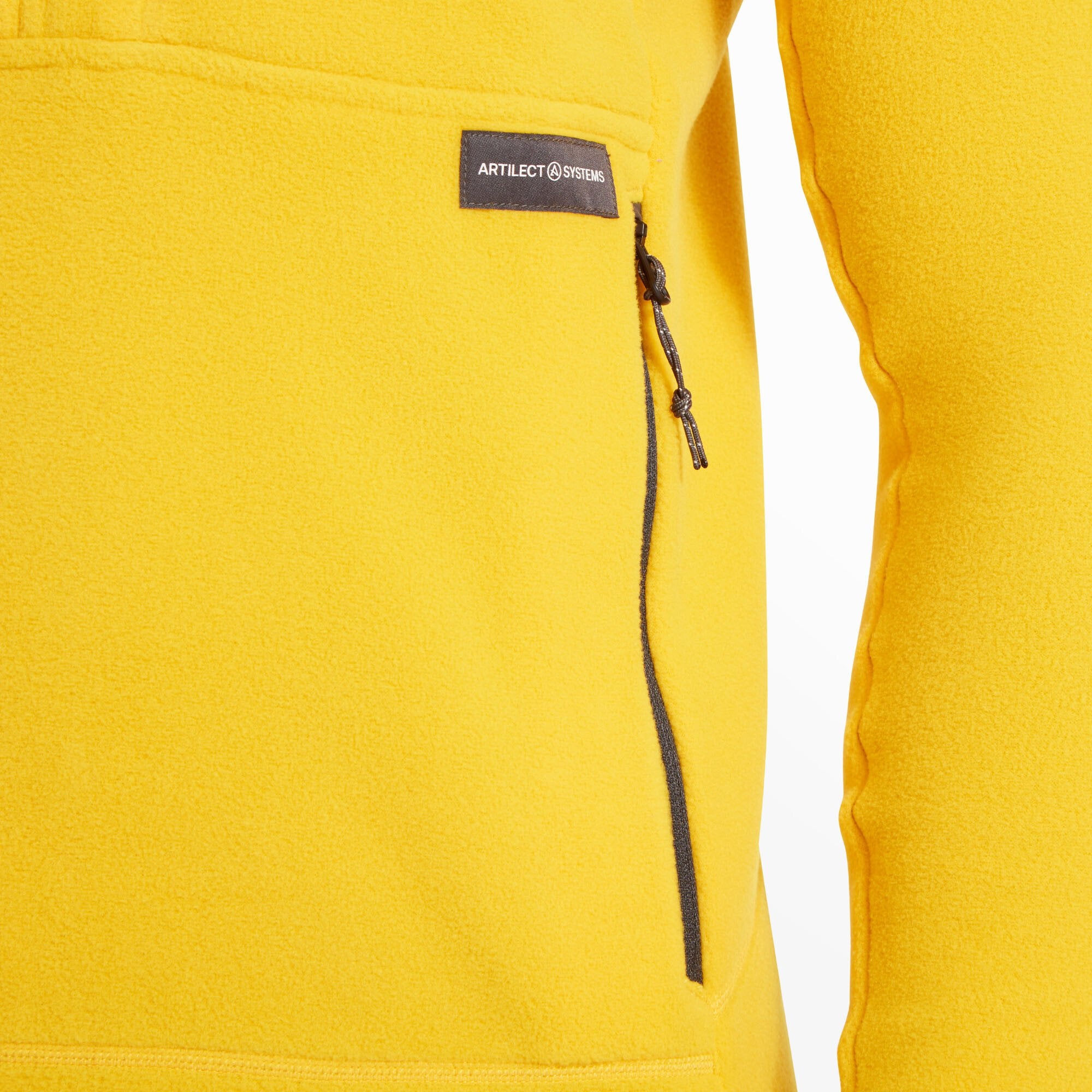 A close-up of the lower front right side of the Artilect Performance Mens Halfmoon Bio Pullover Yellow, highlighting one of the zippered hand pockets. The "Artilect Systems" logo patch is stitched above the zipper, and the fleece fabric’s dense, warm texture is clearly shown.
