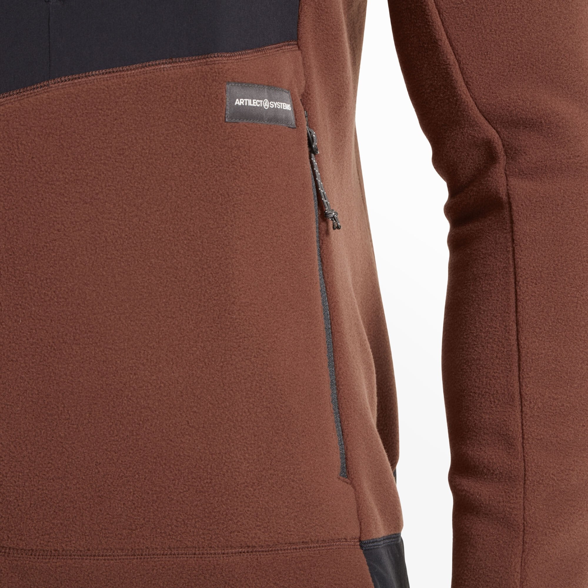 A close-up of the left-hand pocket with a vertical zipper and a visible “Artilect Systems” tag just above. The pocket is set within the burgundy fleece fabric, bordered by the contrasting black bottom section on the Artilect Performance Mens Supermoon Bio Hoodie Burgundy.