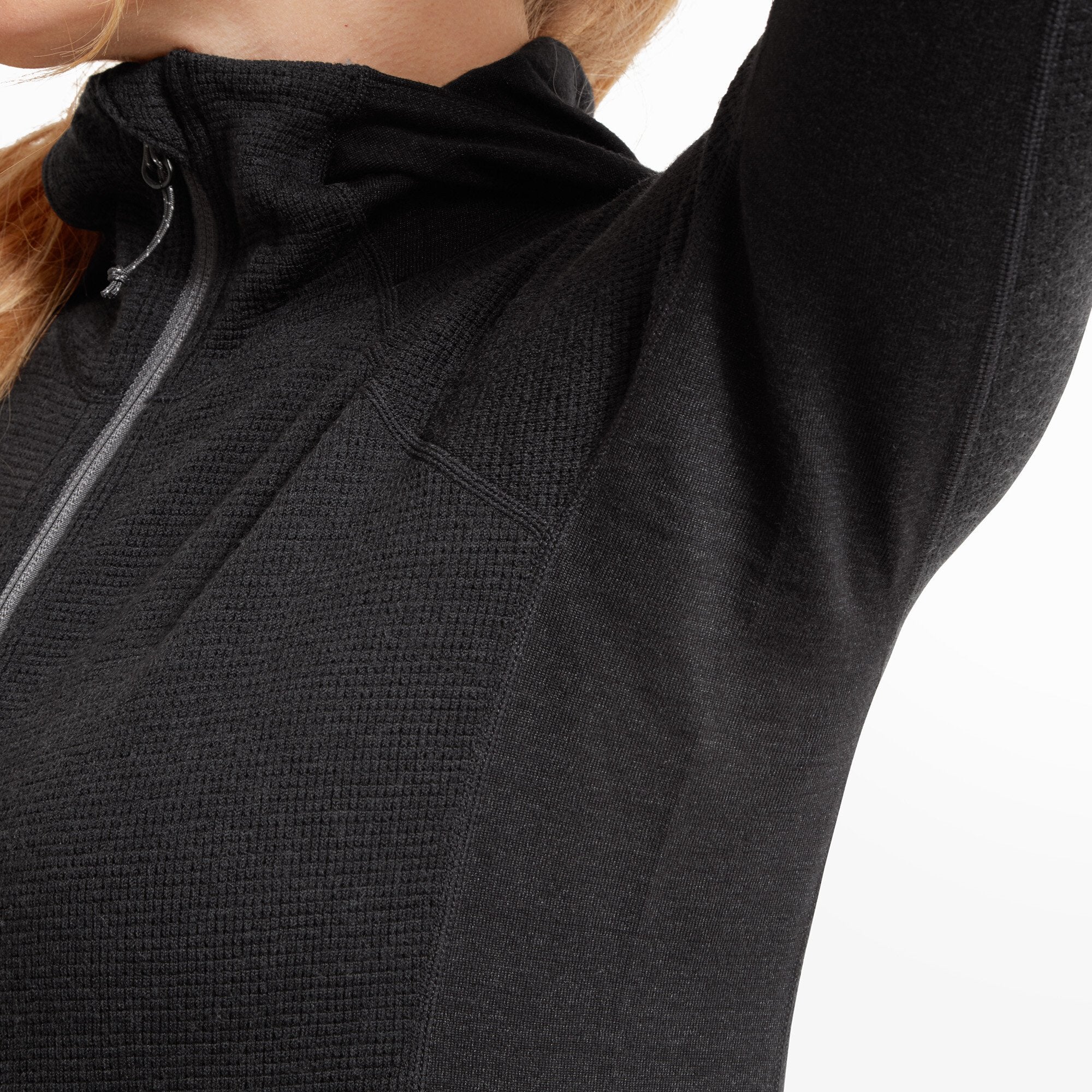 Tight shot of the underarm area of the Artilect Performance Womens Sundown 250 Half Zip Top Black, revealing the stretch and breathable panel construction. The contrast between the waffle-knit body and smooth underarm panel is noticeable.