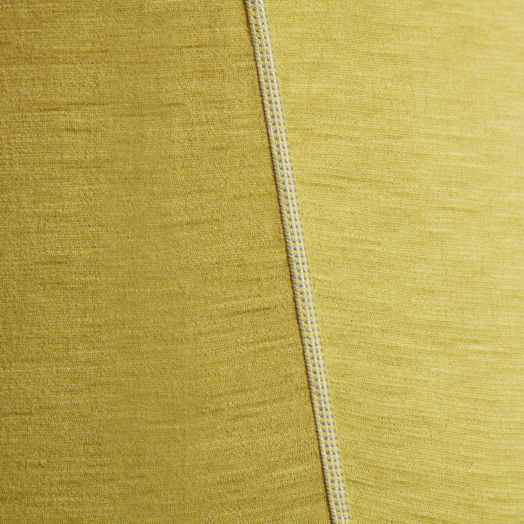 A detailed view of the Artilect Performance Mens Sprint Tee Yellow's texture and stitching. The fabric appears finely knit with a slight stretch, and a clean, reinforced seam runs vertically through the image, showing precise craftsmanship.