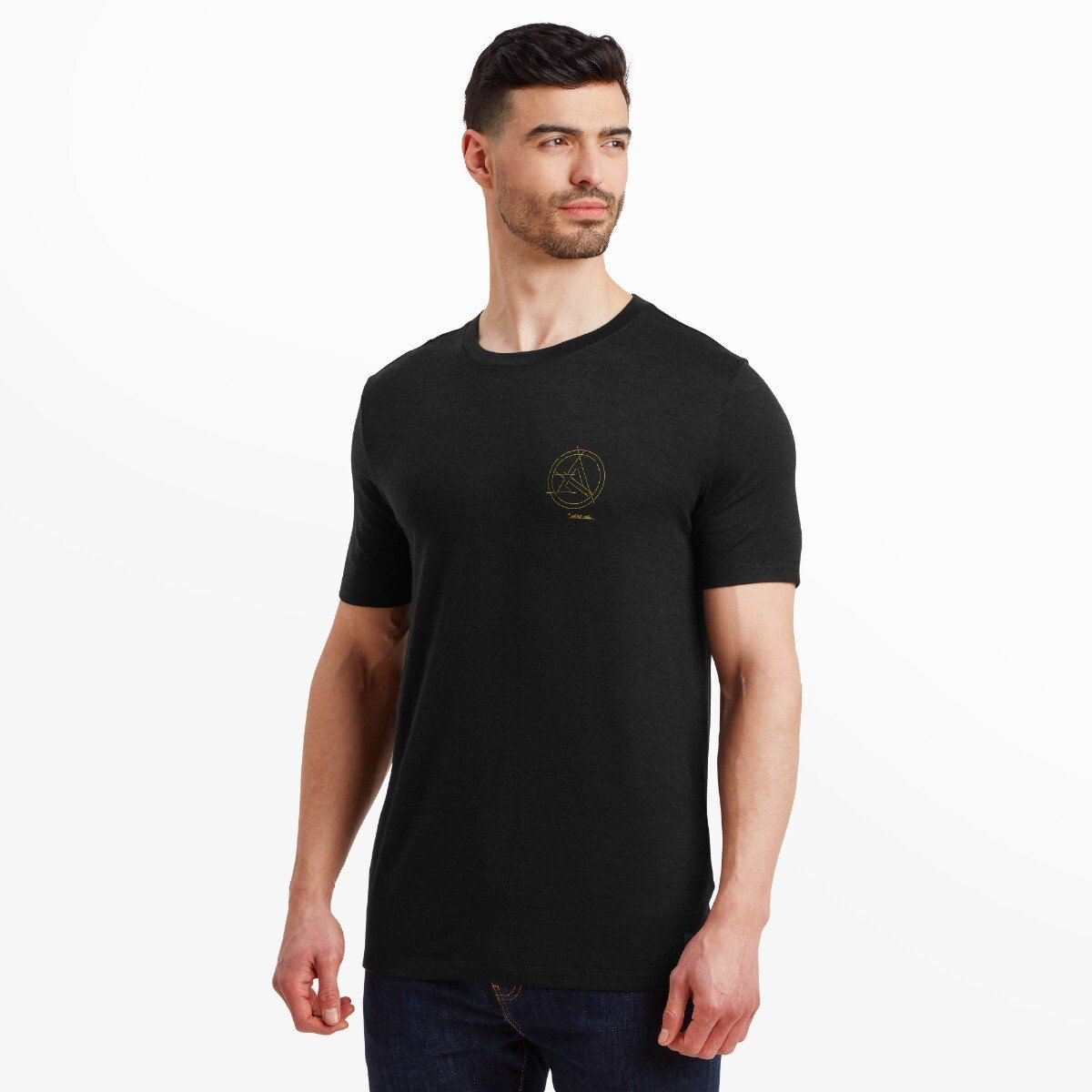 The model poses at a slight angle, showing both the front and left side of the Artilect Performance Mens Utilitee Draft Black. The yellow logo on the chest remains visible, and the model looks confidently off-camera, displaying the shirt's fit and drape naturally.