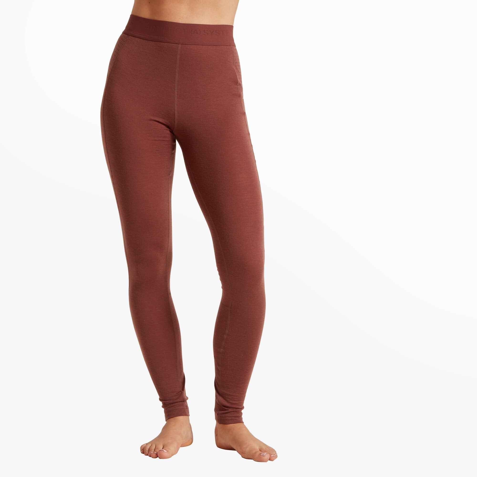 A close-up shot of a woman wearing high-waisted, Artilect Performance Womens Boulder 125 Legging Burgundy. The leggings fit snugly around her hips and legs, and she is barefoot. The waistband appears to be elastic and has subtle branding.